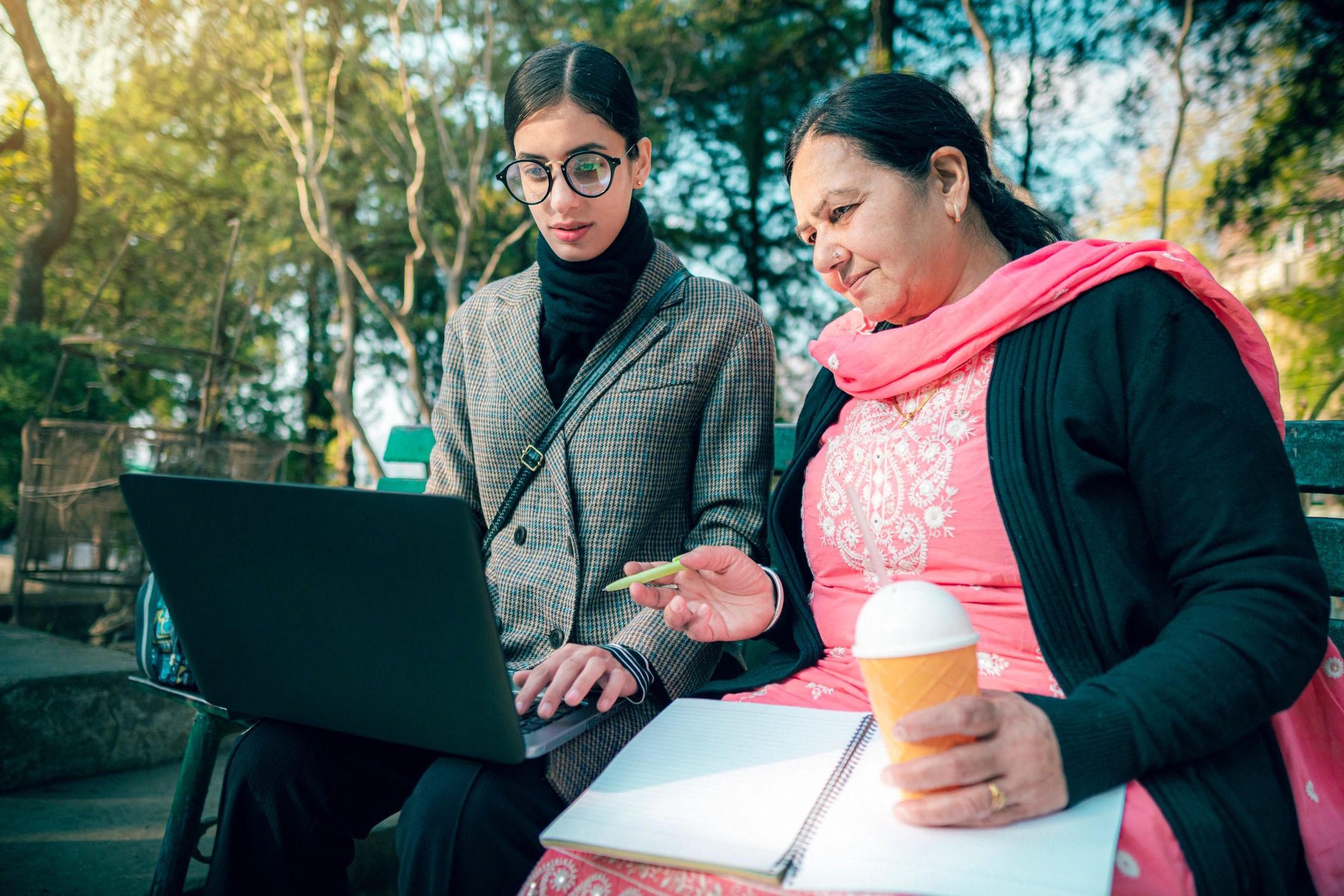 Two professionals in a coaching-style working session with a laptop